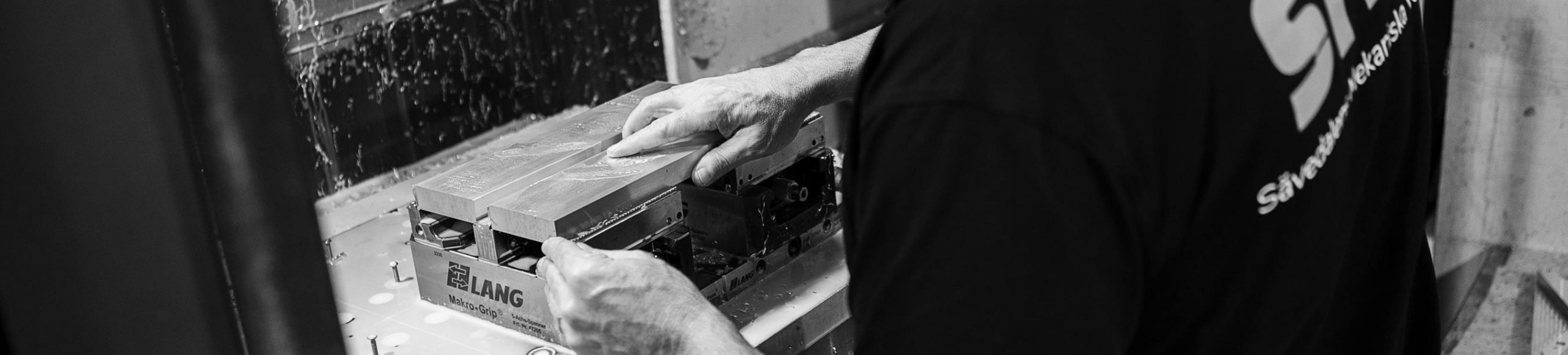 Operator setting up a part for machining at SMV