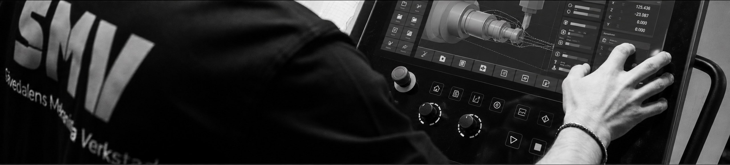 Operator running the machine from the touchscreen control panel at SMV
